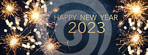 HAPPY NEW YEAR 2023 Party background greeting card  - Sparklers and bokeh lights, on dark blue night sky