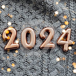 Happy New Year 2024 Postcard. Number 2024 on gray knitted background. Copy space
