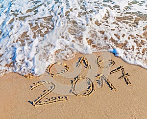 Happy New Year 2017 replace 2016 concept on the sea beach