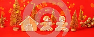 Happy New Year`s 2022 set of gingerbread man in face mask and house from ginger biscuits on classic traditional red background,