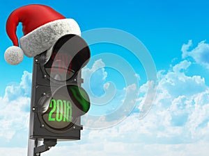 Happy new year 2018. Santa hat on the traffic light with green l