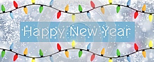 Happy New Year - A snowflake background banner with multiple colour Christmas Tree lights