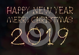 Happy New Year 2019 text hand written sparkles fireworks with Colorful fireworks of various colors at night