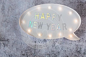 Happy New Year text in lightbox on grey minimalistic background