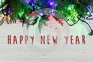 Happy new year text sign on christmas frame of garland lights on