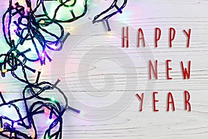 Happy new year text sign on christmas frame of garland lights. c