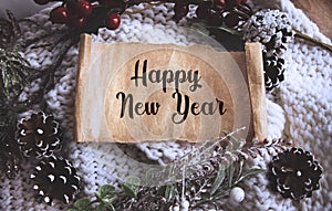 HAPPY NEW YEAR text written on craft paper against the background of New Year`s decor. View from above. Christmas or winter