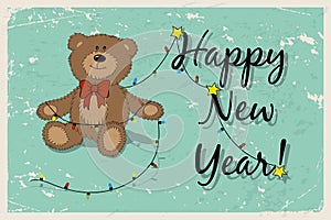 Happy New Year vintage postcard with funny Teddy bear and garland.