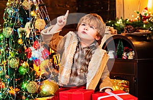 Happy new year. Winter Christmas emotion. Gift emotions. Happy little child dressed in winter clothing think about Santa