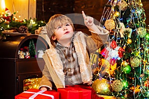 Happy new year. Winter Christmas emotion. Gift emotions. Happy little child dressed in winter clothing think about Santa