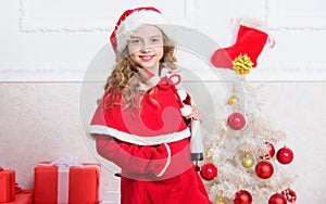 Happy new year winter holidays. Kid near christmas tree hold winter skates. Little girl satisfied christmas gift. Best