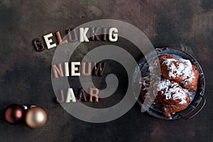 The Happy New Year wish in Dutch with the national delicacy called oliebollen or dougnut balls