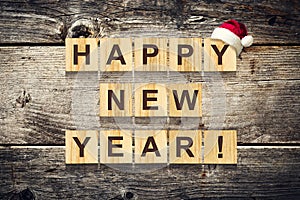 Happy New Year. Words made up of alphabet on wooden cubes. Wooden background. Christmas, New Year background