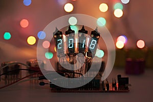 Happy new year is written with a lamp light. Radio electronic lamps. 2018. Original designed congratulation with a