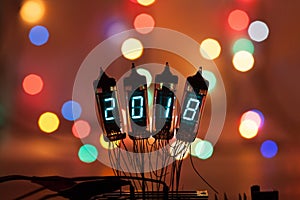 Happy new year is written with a lamp light. Radio electronic lamps. 2018. Original designed congratulation with a