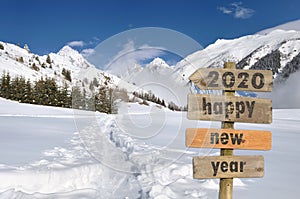 2020 happy new year written on a postsign in the snow photo