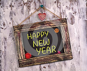 Happy new year written on Vintage sign board