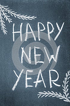 Happy New Year written in white chalk on a chalkboard