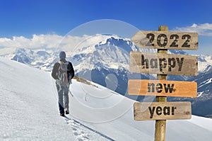 2020 happy new year wrtten on a postsign in snowy landscape photo