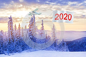 Happy New Years 2020 concept.  Airplane with message number 2020