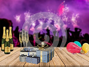 Happy new years party table with champagne presents and balloons with partying crowd and fireworks background