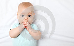 Happy newborn baby on bed