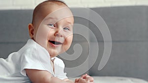 Happy newborn baby smiling closeup