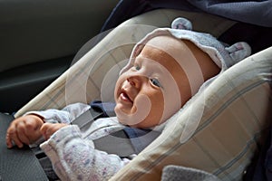 Happy newborn in car seat