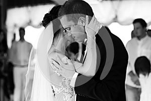 Happy newlywed bride and groom dancing at wedding reception closeup b&w