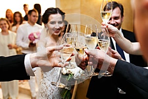 Happy newlywed bride and groom at wedding reception eating and d