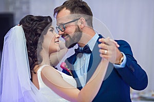 Happy newlywed couple smiling at their first dance at wedding re