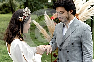 Happy newlyweds exchanging rings at the wedding ceremony. Wedding. The betrothal