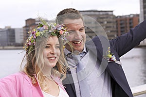 Happy newlyweds just married wedding couple couple smiling - beautiful girl with bouquet of flowers and floral wreath in her hair