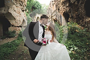 Happy newlyweds near the ancient castle on the walk