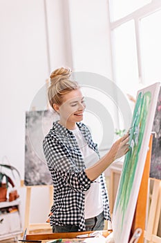 Happy nice lovely girl cleans off unnecessary paint