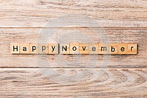 Happy november word written on wood block. Happy november text on table, concept