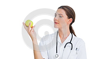 Happy nurse holding an apple