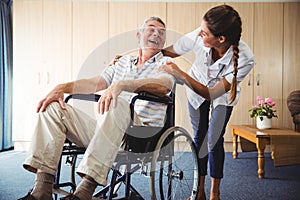 Happy nurse smiling to his patient