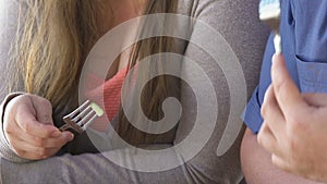 Happy obese man and woman eating fresh vegetable salad outdoors, weightloss