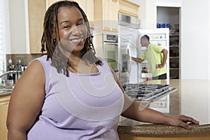 Happy Obese Woman At Kitchen Counter