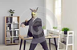 Happy office worker in donkey mask has fun at end of work day, wants to party and dances