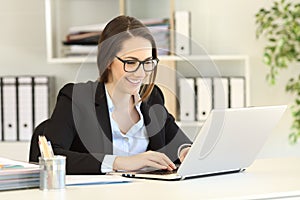 Happy office worker with eyeglasses working online
