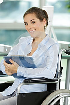 Happy office worker in wheelchair