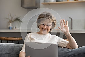 Happy old 60s retired woman holding video call.