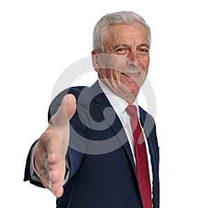 Happy old businessman ready to shake hands