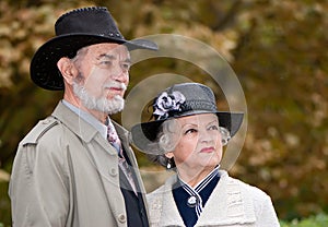 Happy old coule in autumnal park