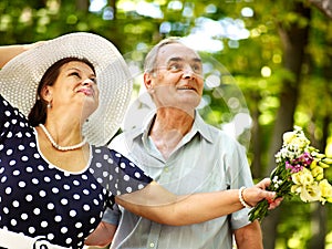 Happy old couple with flower.