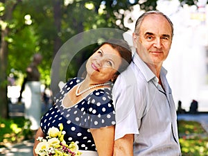 Happy old couple with flower.