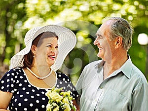 Happy old couple with flower.