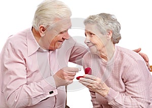 Happy old couple with heart-shaped engagement ring